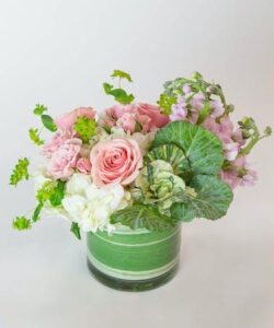 White and pink flowers in a round glass jar