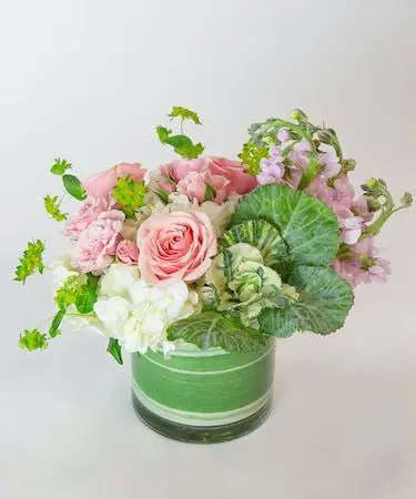 White and pink flowers in a round glass jar